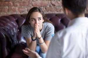 teenage girl listens as therapist explains how a personality disorder treatment program can help