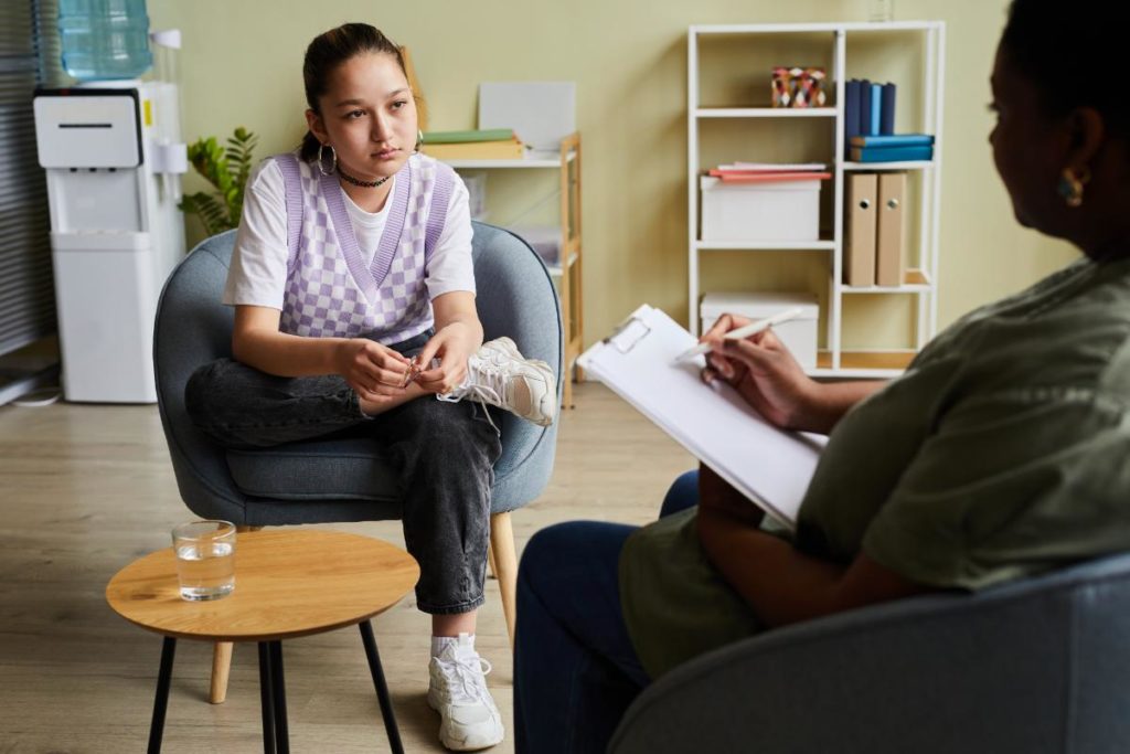 Two people in a session of psychotherapy for teens