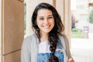 female teenager smiling as she celebrates World Teen Mental Wellness Day