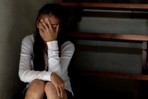 teenage girl sitting on steps with her head in her hands indicative of 5 facts about teen depression you may not know