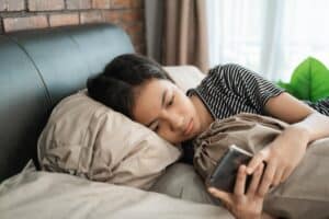 teenager isolating themselves in their room from suffering the effects of teen bullying