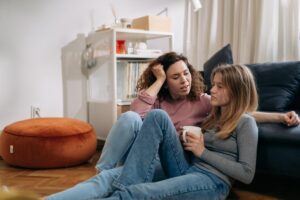 Mother talking to teenage daughter trying to understand how to help a teen who suffers from depression