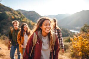 smiling teenager girl hiking with friends and engaging in self-care activities to calm anxiety