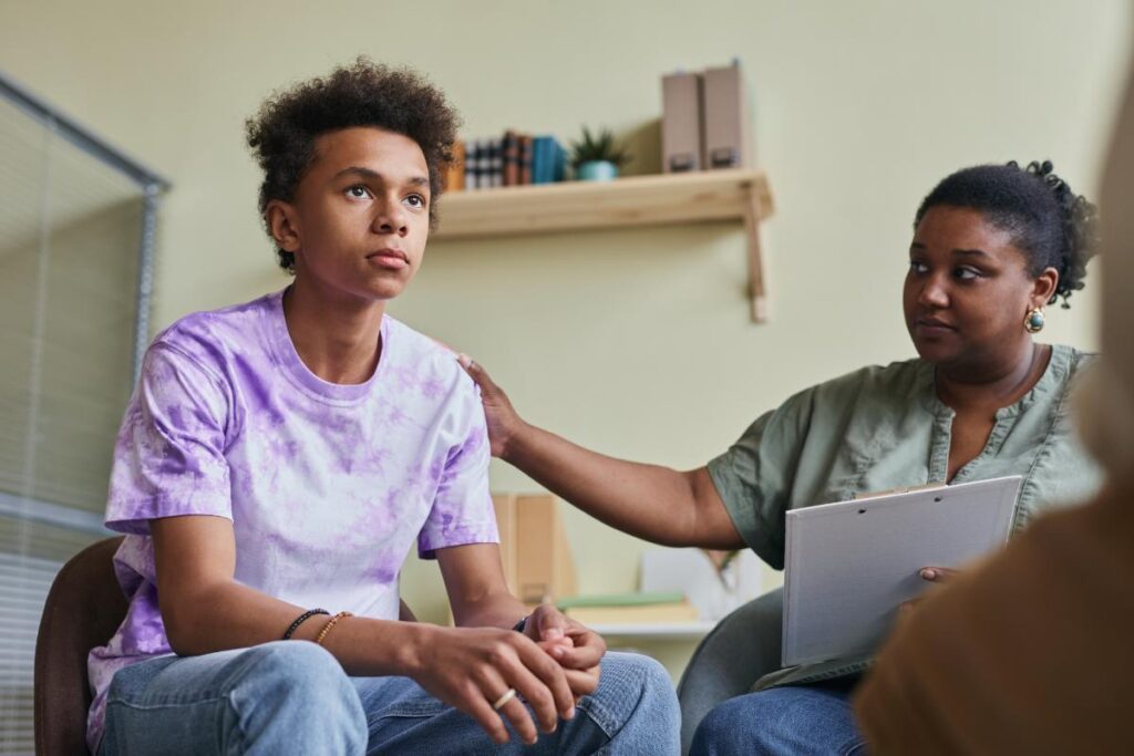 parent consoling her teenage son unsure how to help your teen with depression