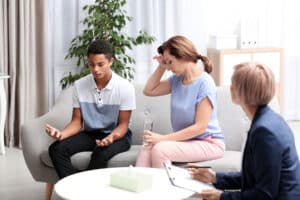 behavioral health therapist with mother and teenage son discussing how to plan an intervention for your teen